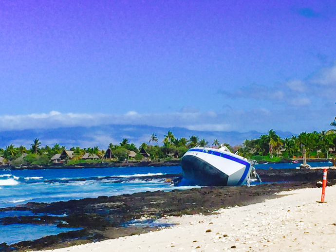 Vessel Hawaii Aloha lays on its side at Kona Village Beach.  Click here to go to the article in West Hawaii Today